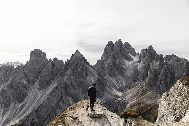 istock Hiker Standing on Rocky Ridge in the Dolomites 2198455558
