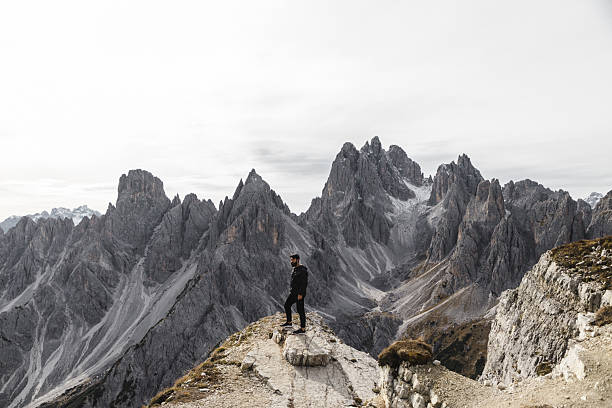 istock Hiker Standing on Rocky Ridge in the Dolomites 2198455590