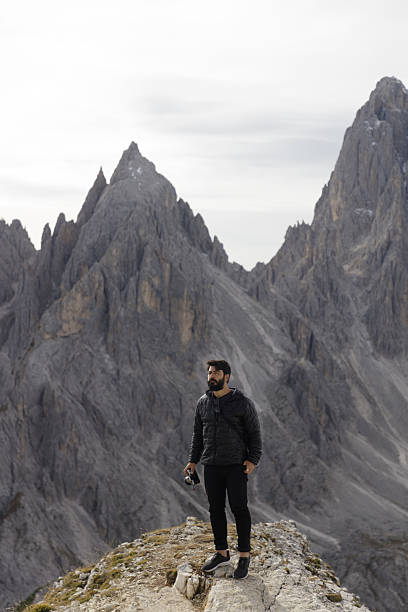 istock Hiker Standing on Rocky Ridge in the Dolomites 2198455633