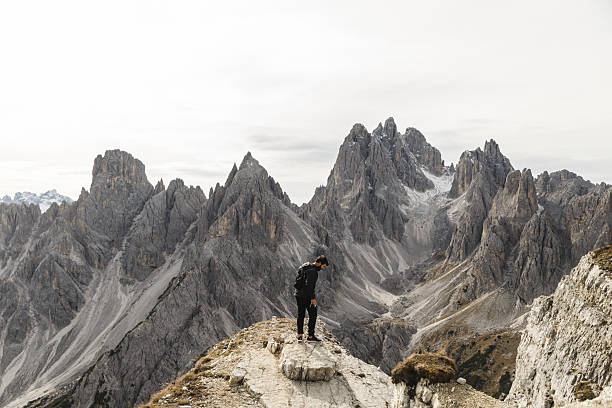 istock Hiker Standing on Rocky Ridge in the Dolomites 2198455676