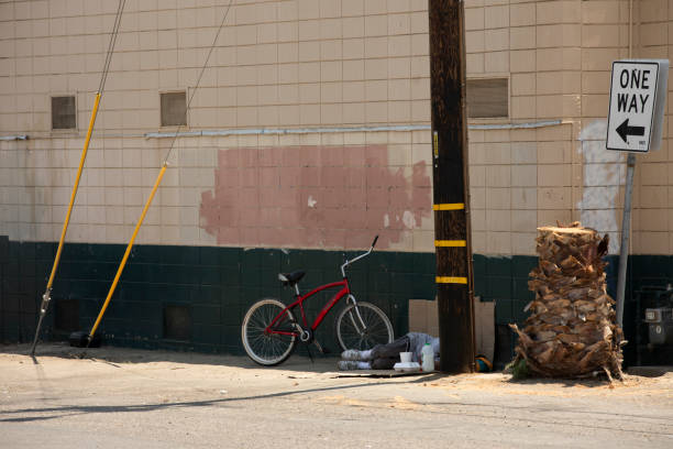 High angle close-up view of the projected shadow of a bicycle over a concrete wall lit by the morning sun