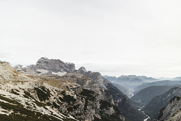 Close-up shots of a hand holding a smartphone compass app, with the Tre Cime di Lavaredo peaks in the Dolomites, Italy, visible in the background. The images combine technology and nature, showing navigation tools used in outdoor exploration and hiking.