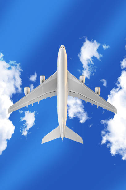 Airplane Flying Through Clouds Against a Clear Blue Sky