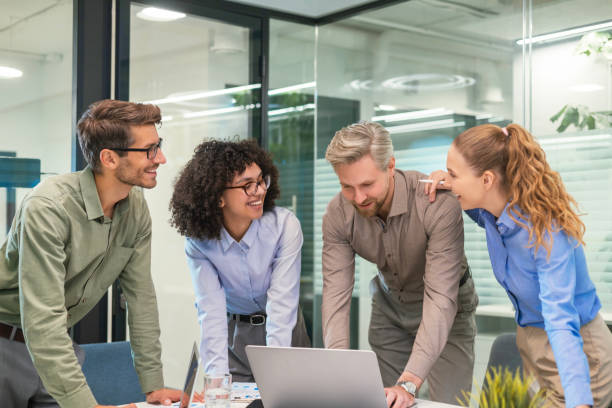 istock Business people discussing work together using a tablet and laptop taking notes in a modern office 2198463090