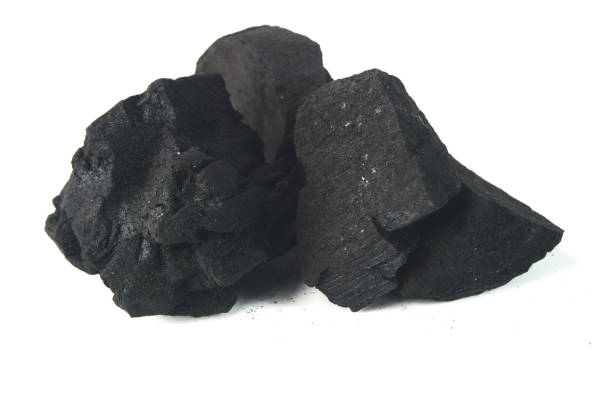 istock Close-Up of Black Charcoal Pieces on a White Background 2198465311