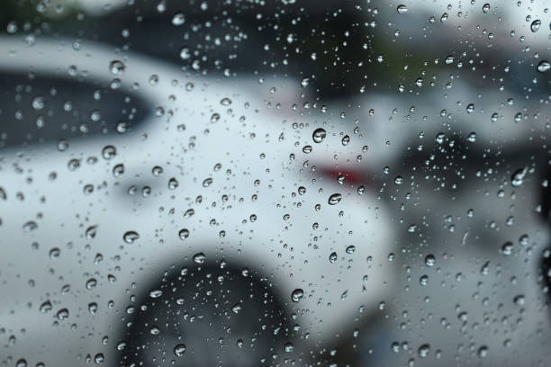 istock water drop on mirror in defocused car parking background 2198465537