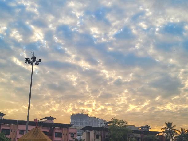 istock Townscape with floodlight against dramatic cloudy sky at sunset 2198465850