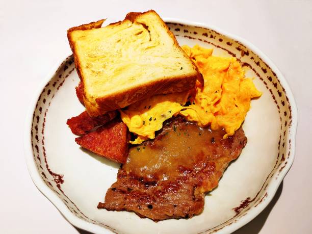 Steak, Luncheon Meat, Corn, Toast and scrambled eggs Breakfast