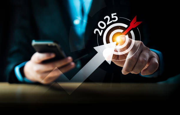istock Businessman using smartphone and touching virtual target with 2025 and dart hitting the center, symbolizing business goals, future planning, digital strategy, success, innovation, financial growth 2198468745