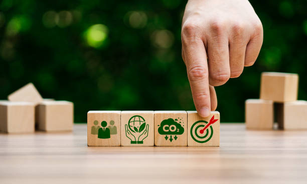 istock Hand Arranging Wooden Blocks Representing Sustainability Goals, Carbon Reduction, Environmental Responsibility, and Target Achievement in Green Business Strategy 2198468831