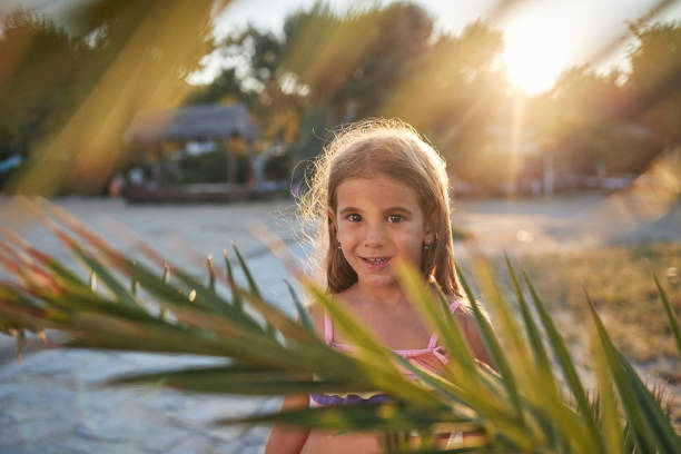 Beautiful girl enjoying sunset on a beach vacation.