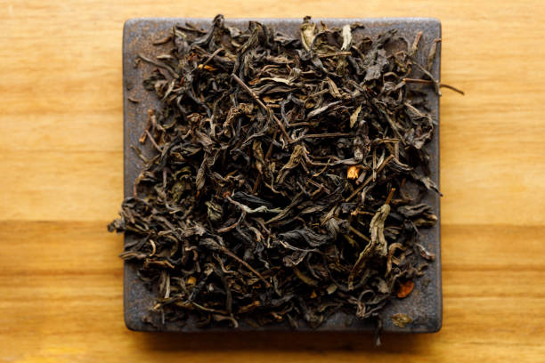 istock Japanese or Chinese jasmine tea leaf on black ceramic plate on wooden background. 2198476949