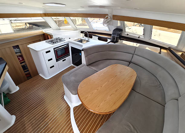istock A cozy living room and kitchen featuring a stylish curved couch and a table located on sailing boat 2198477378