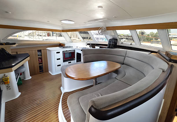 istock A cozy living room and kitchen featuring a stylish curved couch and a table located on sailing boat 2198477549