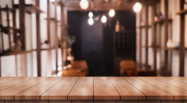 istock Empty wooden table top with lights bokeh on blur restaurant background. 2198477782