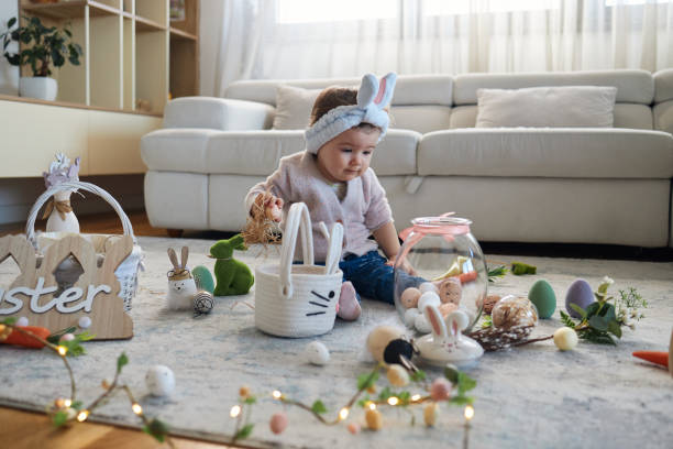 Identical twins having an Easter egg hunt in their garden
