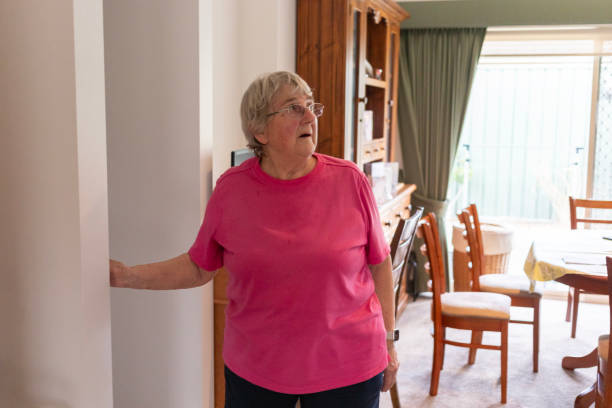 istock Senior woman turning on a light 2198479167