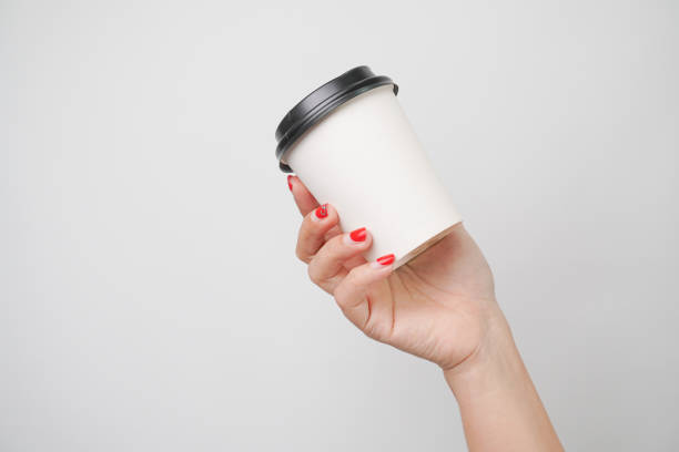 istock Someone hand is holding a paper coffee cup, isolated on white background 2198480416