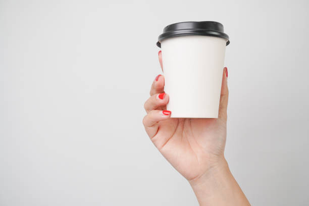 istock Someone hand is holding a paper coffee cup, isolated on white background 2198480432