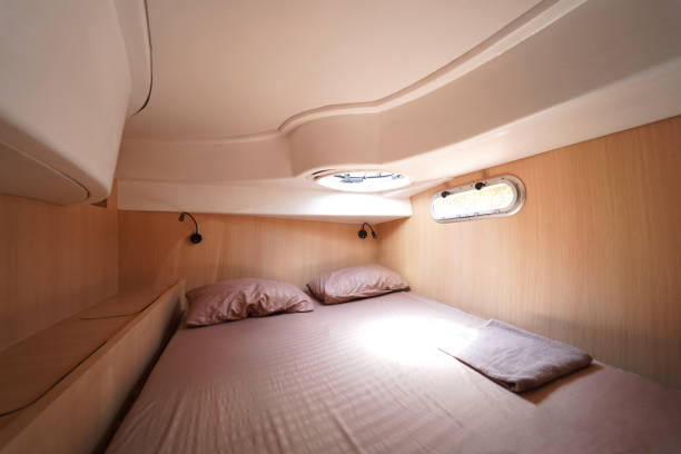 istock Cozy bed on a voyage boat with a window overhead with natural light 2198480546