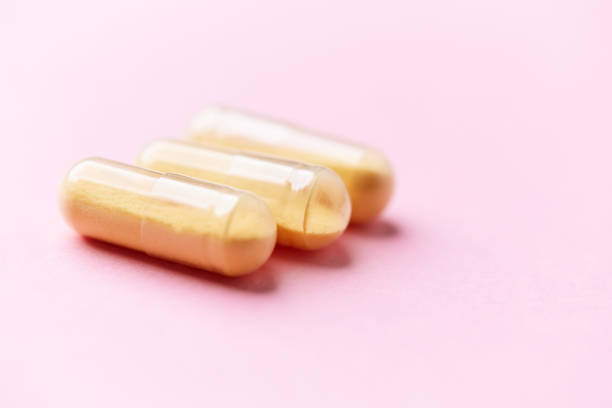 istock Coenzyme Q10 capsules. Dietary supplements. Bright paper background. Close up. 2198480901