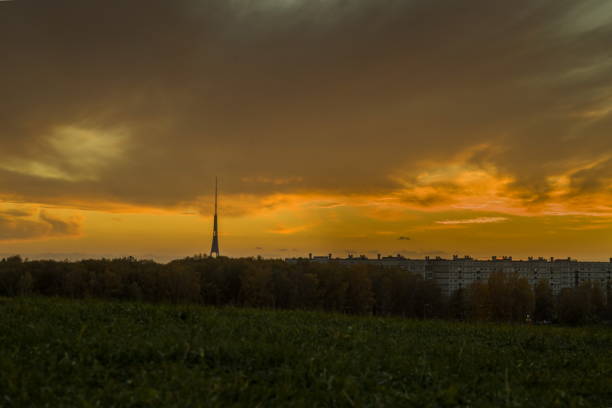istock Landscape with a distant tower or spire silhouetted against a dramatic sunset or sunrise sky. 2198485315
