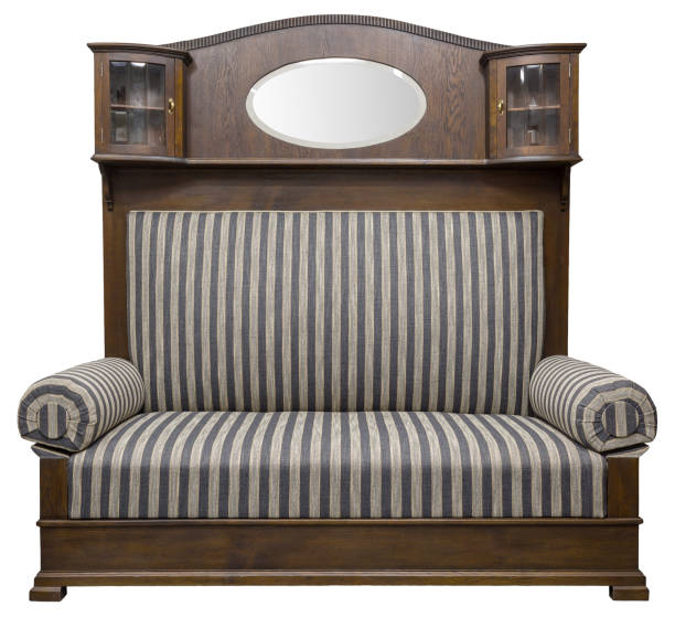 Unique vintage or antique settee with a built-in cabinet and display case. Dark wood construction with striped upholstery. Statement piece for interior design.