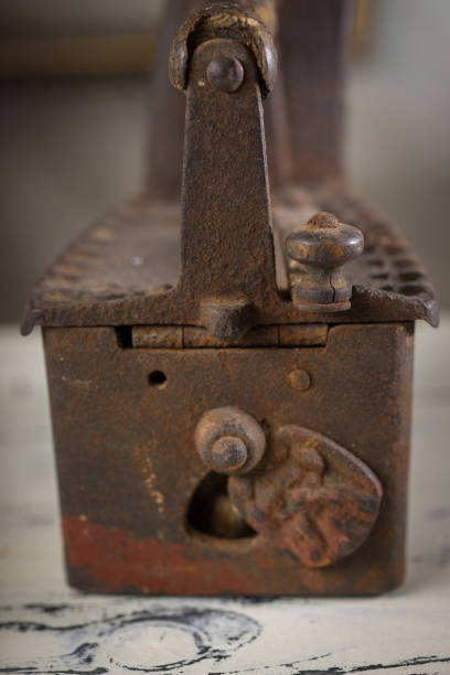 istock Rusty Vintage Iron with Wooden Handle Sitting on a Table 2198486070
