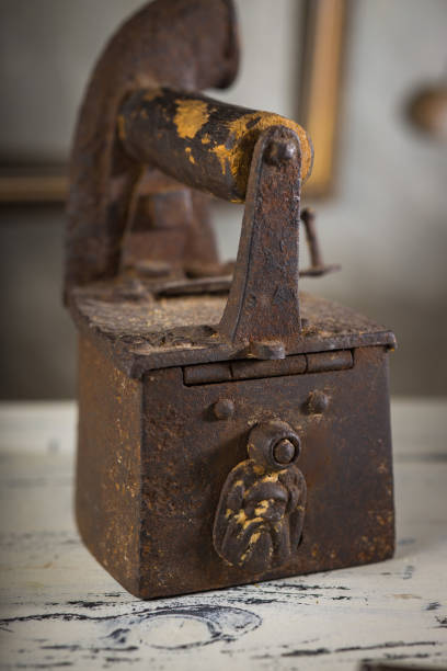 istock Rusty Vintage Iron with Wooden Handle Sitting on a Table 2198486074