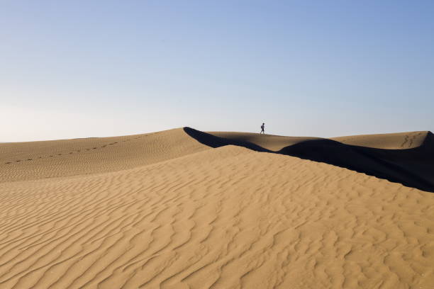 istock Maspalomas Dunes in Gran Canaria. Textured sand dunes with patterns, shadows, and faint footprints. 2198487885