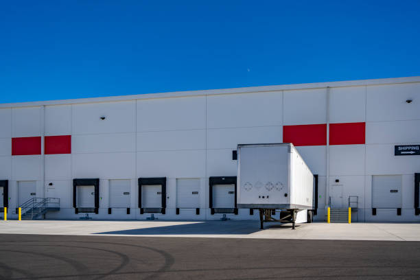 istock Dry van semi trailer without semi truck loading cargo standing in warehouse dock gate 2198488985