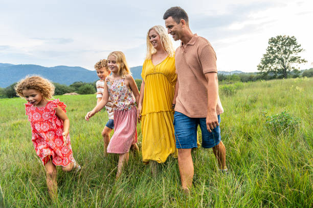 istock Joyful Caucasian Family Strolling Through Lush Meadow 2198489099