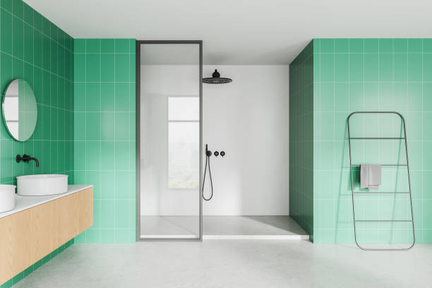 istock Modern bathroom with round mirrors and white sinks on wooden vanity against blue tiled wall. 3D Rendering 2198489203