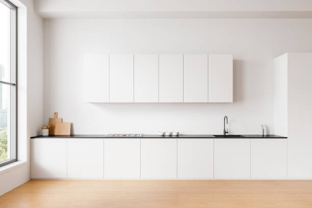 istock Modern minimalistic kitchen with white cabinets, large window, and wooden floor. 3D Rendering 2198489516
