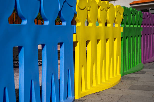 istock A row of colorful plastic figures are lined up in a row. 2198491781