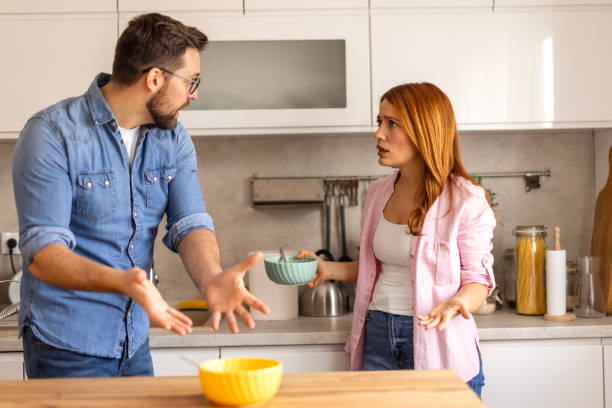 istock Couple is having a tense moment in the kitchen during breakfast engaged in an argument. Emotional contrast of daily life capturing the frustration or disagreement between the two individuals in a home 2198492091