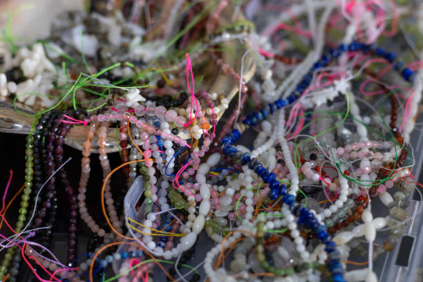 istock Colorful array of beads and threads displayed in a handcrafted bowl at a local market 2198494422