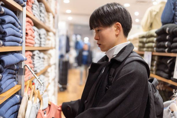 istock Young freelance worker shopping in clothing store 2198495167