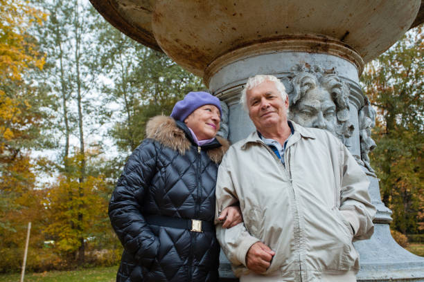 Senior couple having romantic walk in autumn park