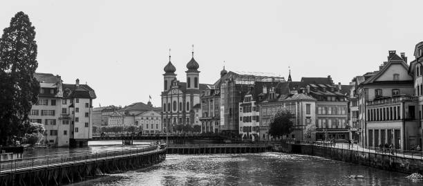 Luzern lake and spectacular old town buildings  view with the Lucerne Jesuit Church, a Catholic and  large Baroque church in north of the alps. Tourist attraction, landscape, city, Europe