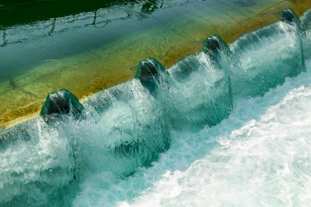 A waterfall with water coming out of it. The water is green and white. There are four waterfalls in the image