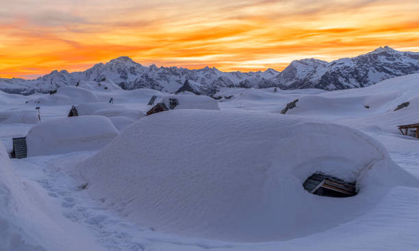 Sunset in Valmalenco at Alpe Prabello. At 2200 meters among the beautiful huts covered with lots of snow. Valtellina landscapes.