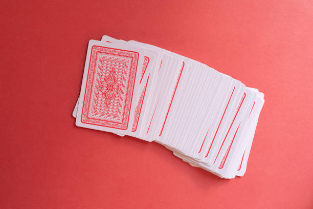 Selection of playing cards in disarray against a soft green background. Leisure games, entertainment and pastime activities abstract concept symbol, nobody. Casual play, game theory, winning losing