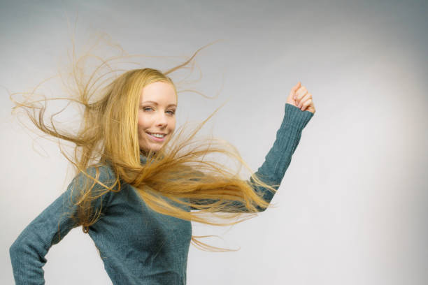Smiling girl with blowing long blonde hair