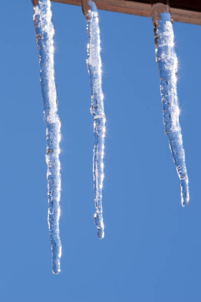 istock Beautiful icicles stretching out from under the roof 2198503661