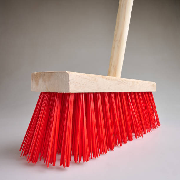 istock Clean Red street broom in studio light on white background 2198505035