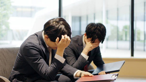 istock Asian businessman depressed at work 2198505042