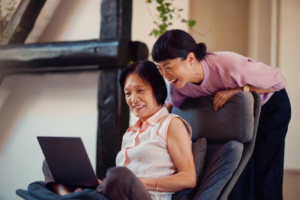 istock Mother and Daughter Bonding Over Technology in a Cozy Living Room Setting 2198506473