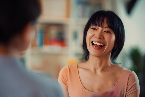 istock Woman Smiling During a Friendly Conversation at Home in a Warm Atmosphere 2198506506