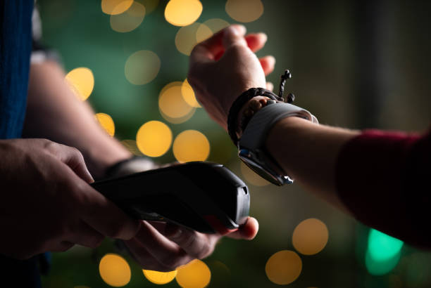 istock Girl Paying Bill With Watch Using Wireless Pos Terminal 2198507472
